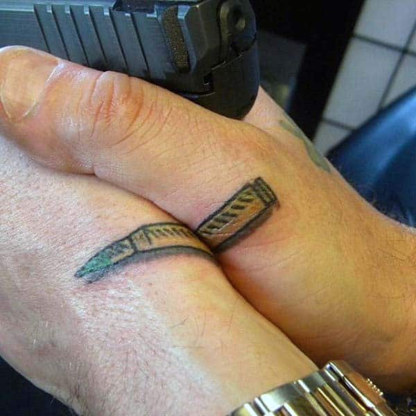 Two Hands Bullets Tattoo For Guys Above Fingers