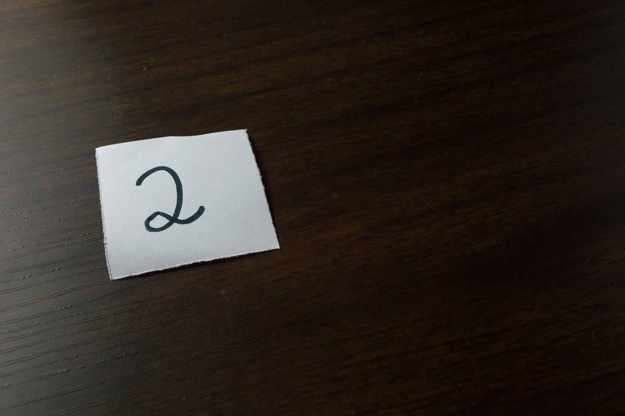 two handwritten on piece of white paper