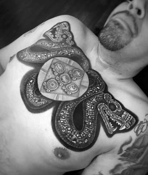 Intricate two-headed snake tattoo on the chest, inspired by Aztec or Mayan art, featuring bold geometric patterns and symbolic details.