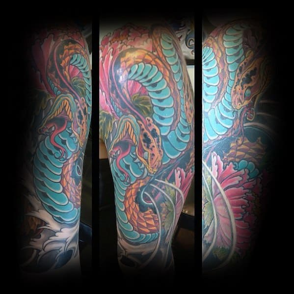 Vibrant two-headed snake sleeve tattoo with bold turquoise and orange scales, surrounded by intricate floral and swirling details.