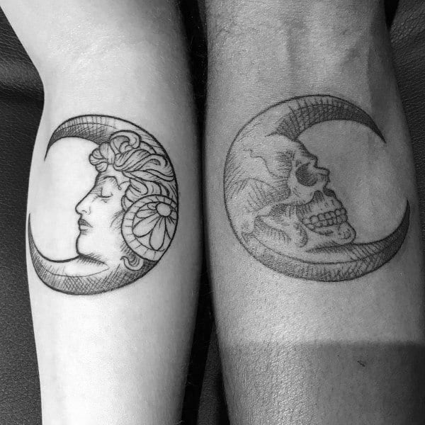 Matching forearm tattoos of crescent moons, one featuring a woman's face and the other a skull, symbolizing love through life and death, balance, and eternity.