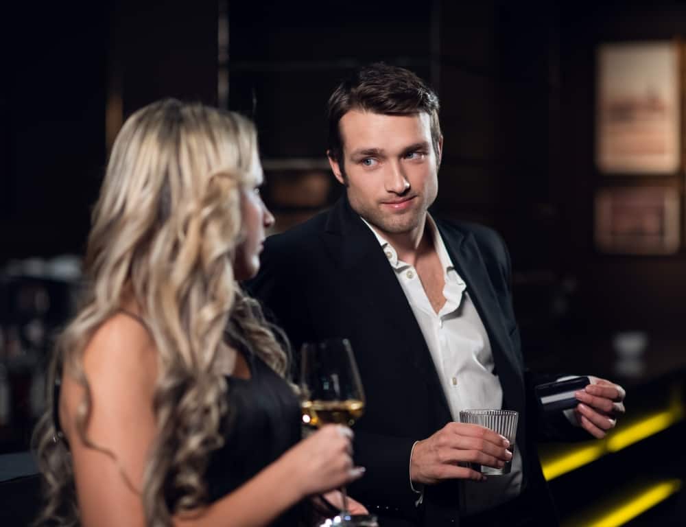 two people drinking cocktail in a club