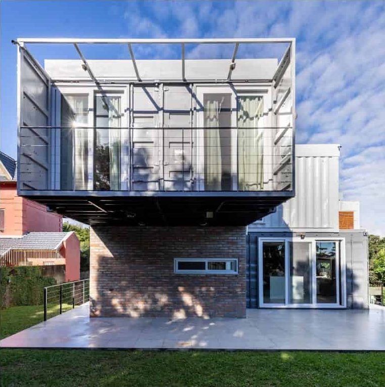 two-story shipping container home with balcony