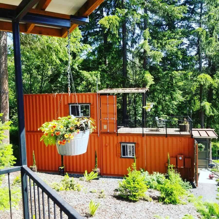 two-story orange shipping container home