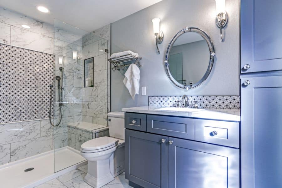 blue cabinet bathroom with large shower with bench seat