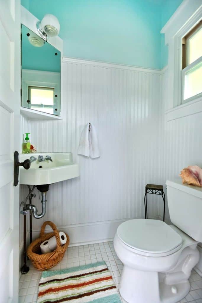 two tone blue and white retro bathroom with corner sink 
