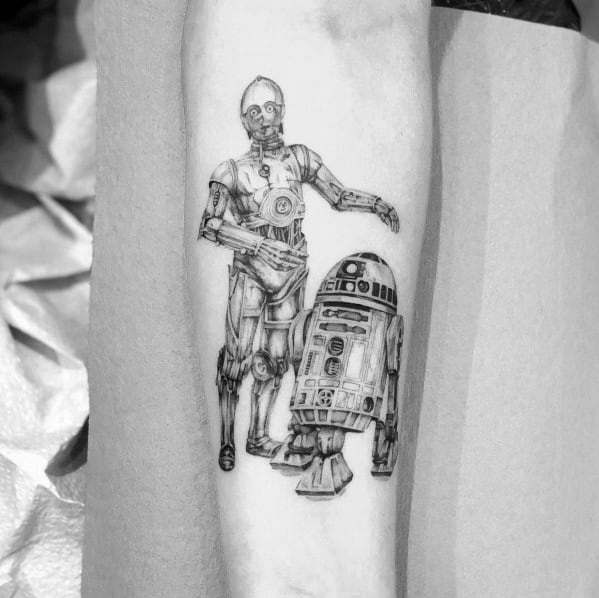 Intricate black and grey C-3PO and R2-D2 tattoo with fine line detailing, capturing the iconic Star Wars duo in a realistic style.