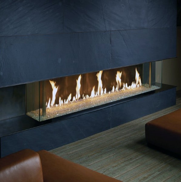 Long linear gas fireplace with glass panels and a sleek dark stone surround.