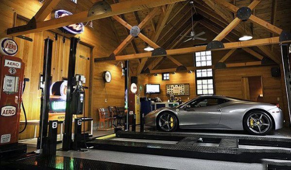 Luxury garage with wooden beams, vaulted ceiling, vintage decor, and a sports car on display.
