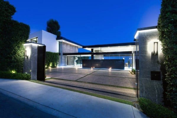 Modern driveway with geometric panels, grass strips, and integrated LED lighting.