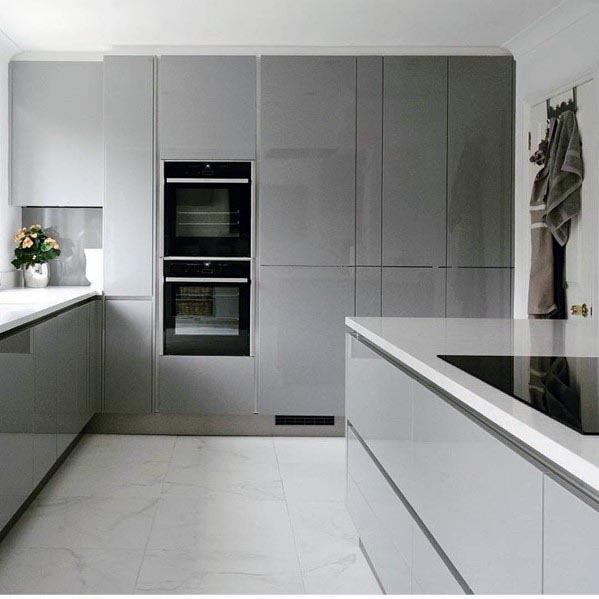 Ultra-modern grey kitchen featuring sleek, glossy cabinets, integrated appliances, and a minimalist design.