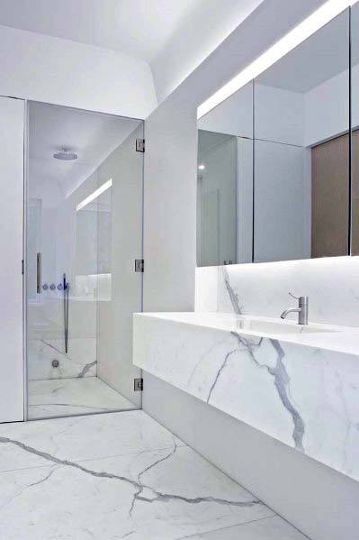 Sleek modern bathroom with a white glass shower and marble countertop