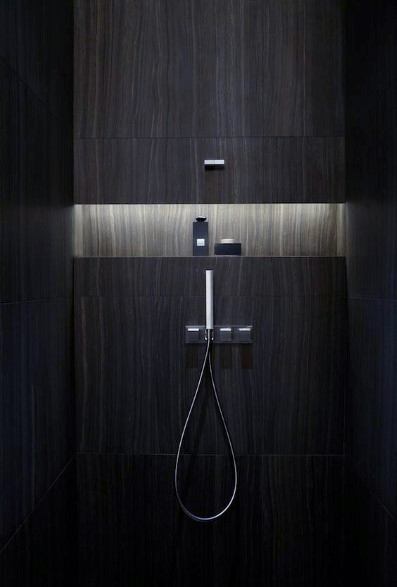Ultra-modern shower with dark wood-inspired tiles, featuring recessed LED lighting in the niche for a sleek and atmospheric design