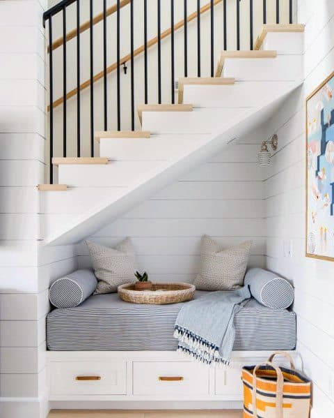 under stair case nook with small sofa