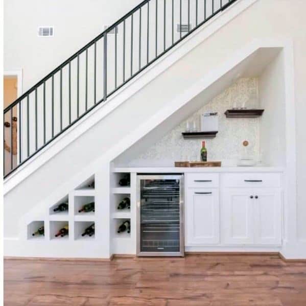 white cabinet wine cellar under stairs