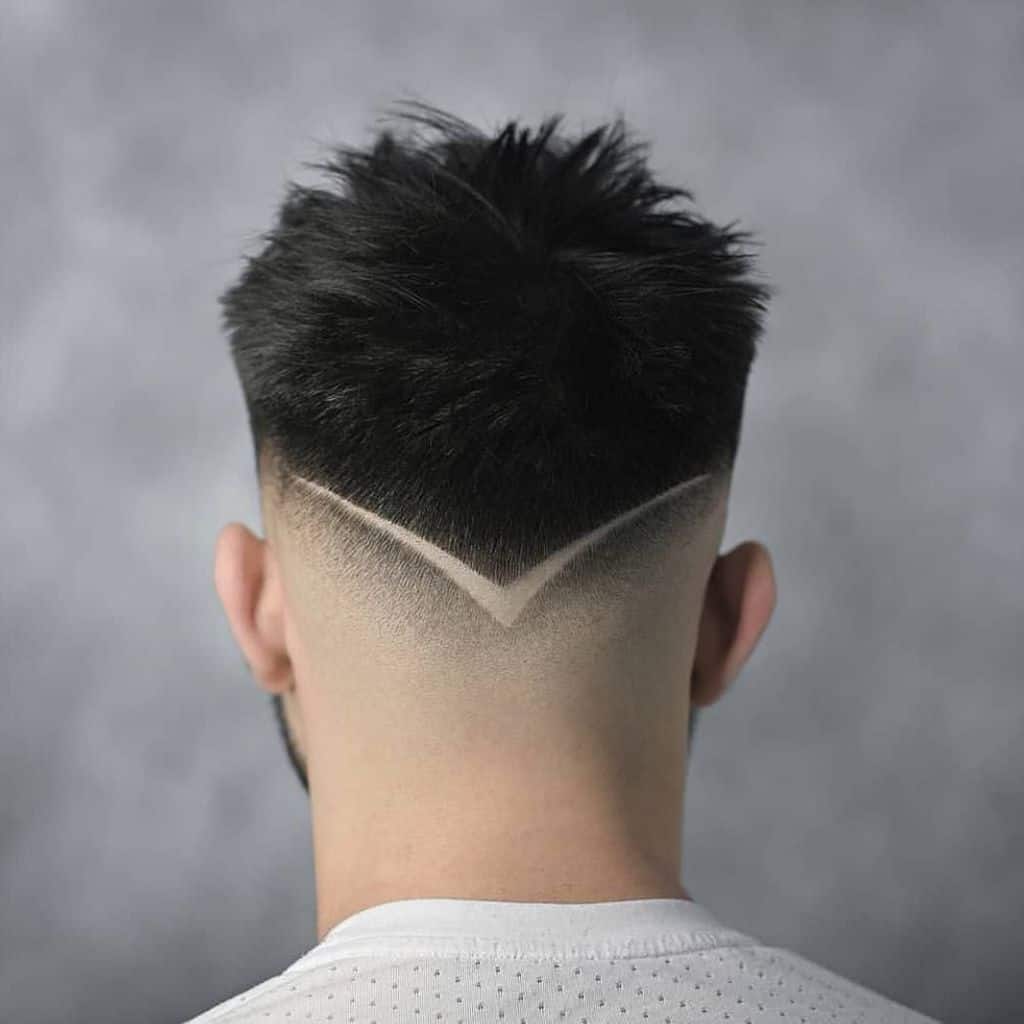A low burst fade haircut with an undercut at the nape of the neck