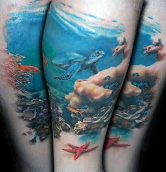 Vibrant underwater scene tattoo with coral reef, sea turtle, fish, and red starfish, covering the calf in full-color realism.