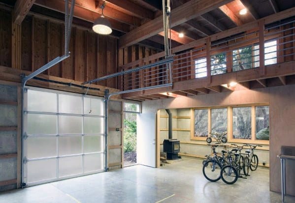 Modern garage with exposed beams, frosted glass door, loft space, and bicycle storage.