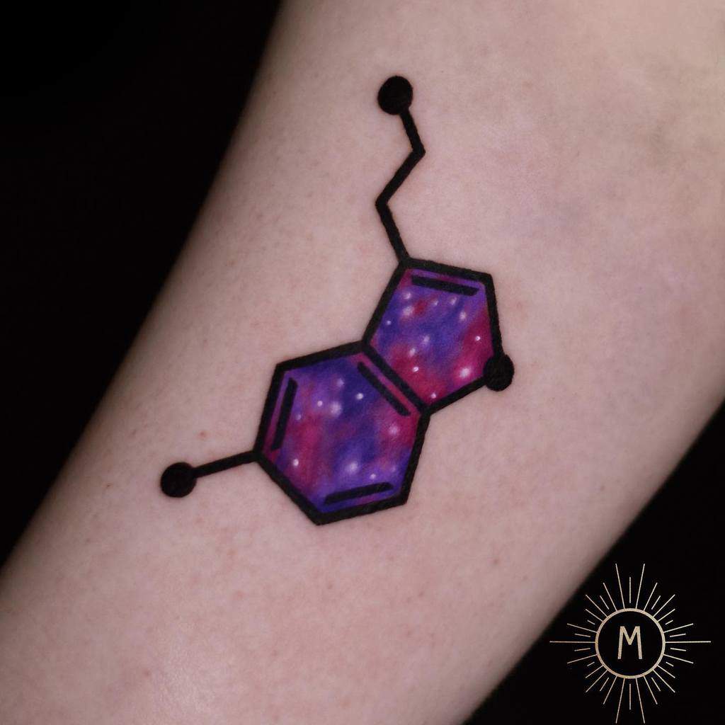 Tattoo of a serotonin molecule design with a galaxy-themed fill on skin
