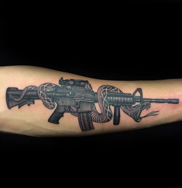 Black and grey AR-15 tattoo with a coiled rattlesnake wrapped around the rifle, symbolizing strength, defiance, and the right to bear arms.