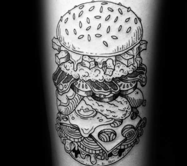 Black and white tattoo of a detailed, multi-layered cheeseburger with various toppings on a person's skin