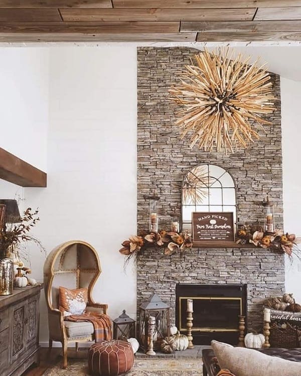 unique brick floor to ceiling fireplace surround accent chair candlesticks chandelier