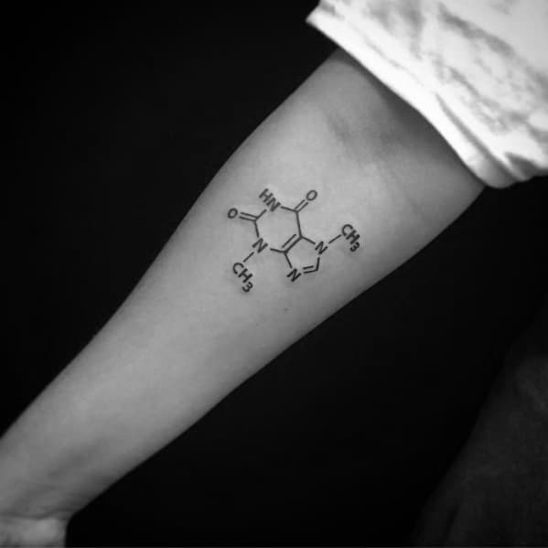 Clean black ink tattoo of the theobromine chemical structure, the compound found in chocolate, placed on the forearm with precise linework.