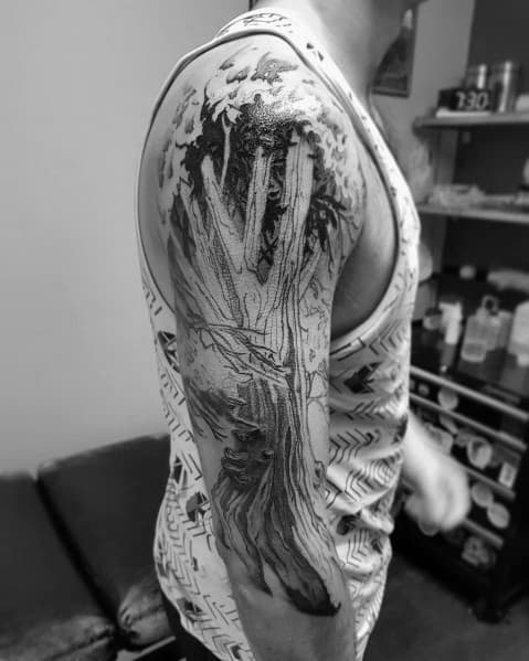 A detailed oak tree tattoo on the upper arm