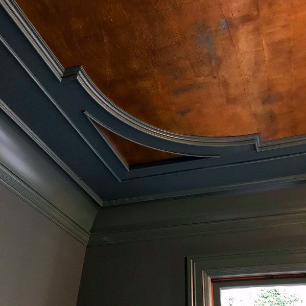 Unique dark grey vintage-style crown molding with a rich copper ceiling, creating an elegant and timeless look for the room
