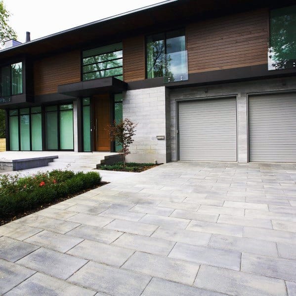 Contemporary concrete driveway with large rectangular slabs and clean, minimalistic lines.