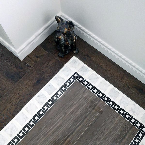 decorative marble entryway tiles with wooden border