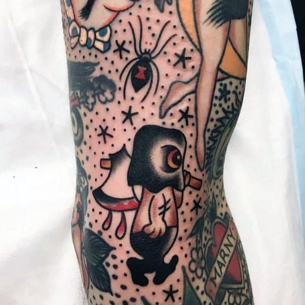 Cartoon-style executioner tattoo featuring a small hooded figure with a glowing eye, carrying a bloodied axe, surrounded by spiders and stars.