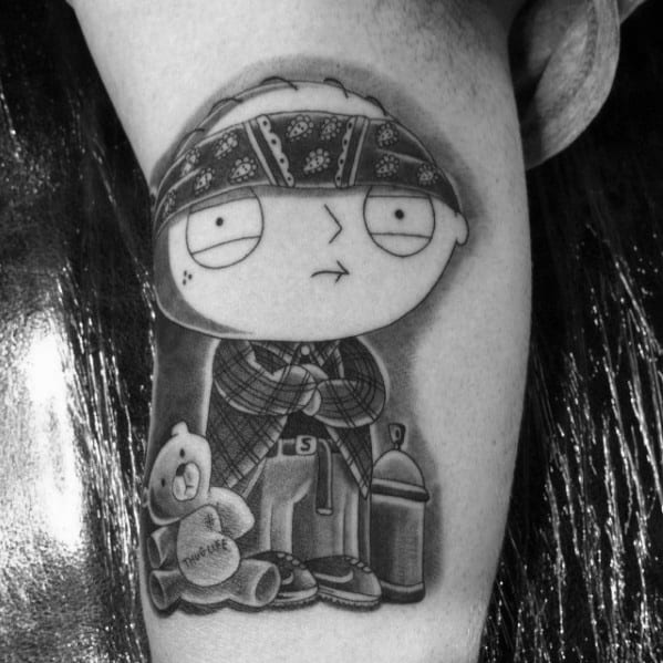 Tattoo of Stewie Griffin from *Family Guy* in a gangster style, wearing a bandana and plaid shirt, with Rupert, a spray can, and cash beside him.
