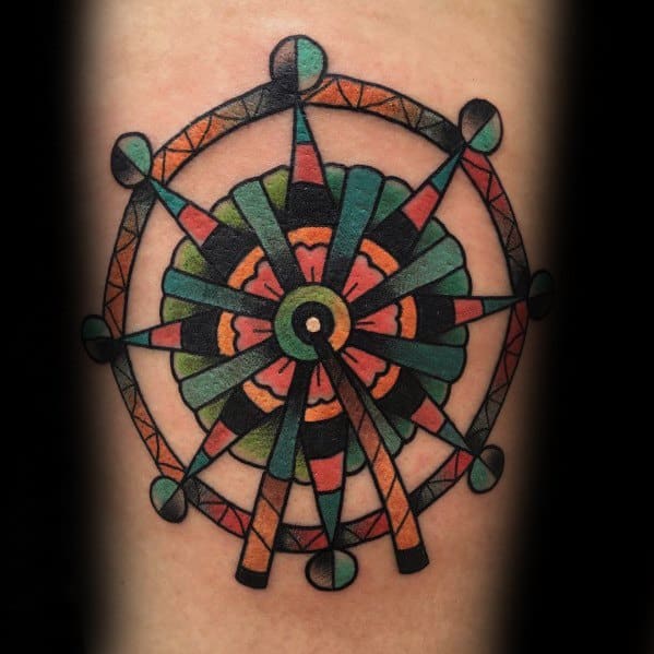 Bold geometric Ferris wheel tattoo with vibrant colors and symmetrical patterns, creating a striking mandala-inspired amusement park design.