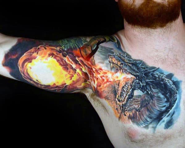 Tattoo of a dragon breathing fire towards a fireball on a person's chest and upper arm