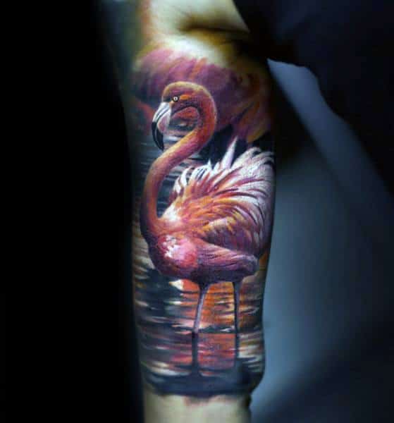 Hyper-realistic flamingo tattoo with stunning details, warm sunset reflections on water, and rich shading for a lifelike and dramatic effect.