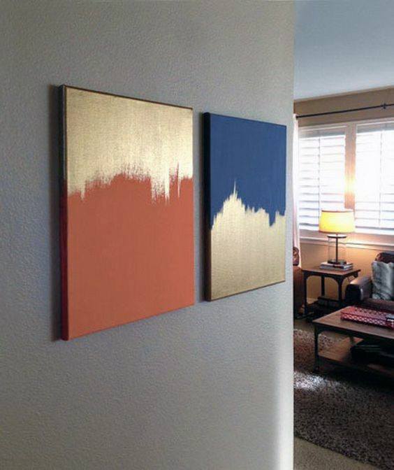 Gold, orange, and blue abstract canvas art hung on a wall in a hallway.