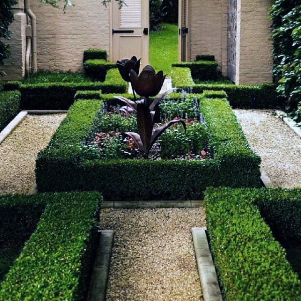 hedge-lined walkway with rotunda centerpiece sculpture