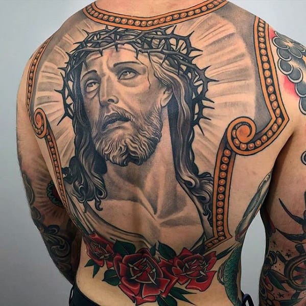 Back tattoo featuring Jesus with a crown of thorns and red roses at the bottom