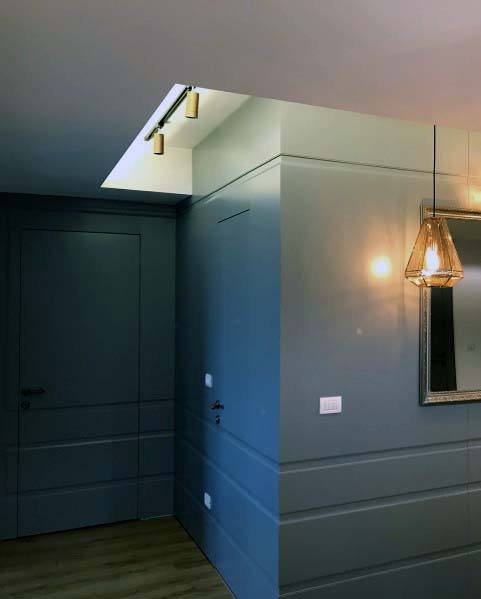 unique hidden door gray painted walls pendant light