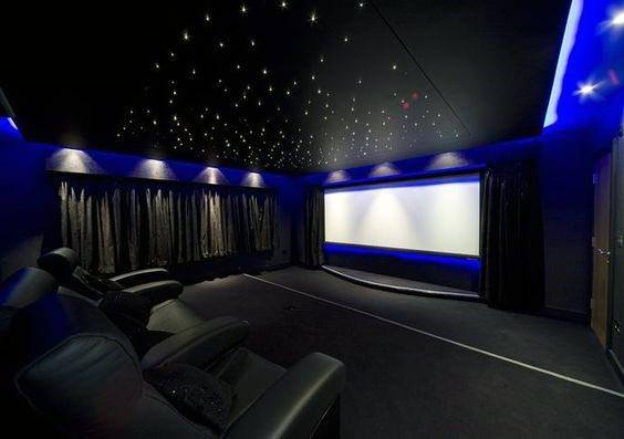 home theater with ceiling stars and black sofas