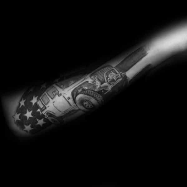 Black and grey tattoo of a rugged Jeep with an American flag background, symbolizing patriotism, adventure, and off-road freedom.