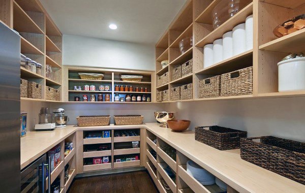 Spacious pantry with light wood shelving, woven baskets, and ample storage for a natural, organized feel.