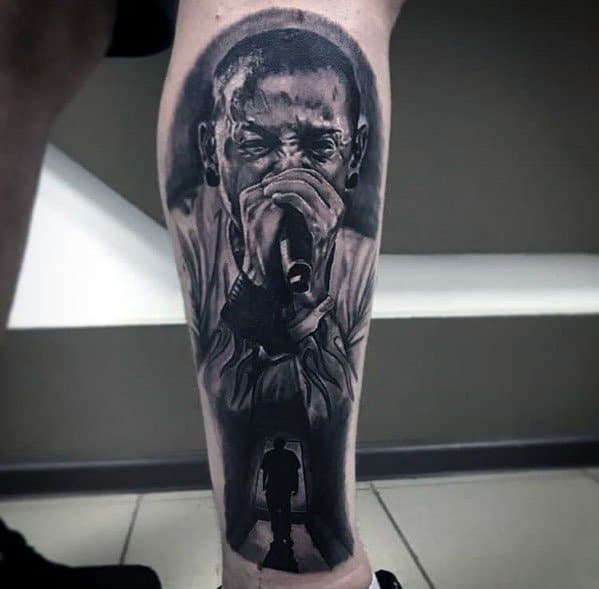 Black and gray tattoo of Chester Bennington singing, with a silhouette of a man walking through a doorway, symbolizing his legacy.
