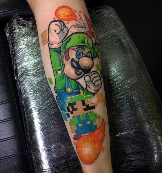 Tattoo of Luigi in a powerful pose with pixelated effects, fireballs, and a retro-style 8-bit Luigi below, blending modern and classic designs.