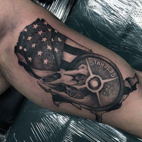Tattoo of a U.S. map filled with an American flag, bull skull, and 20.4 kg weight plate, symbolizing strength, heritage, and patriotism.