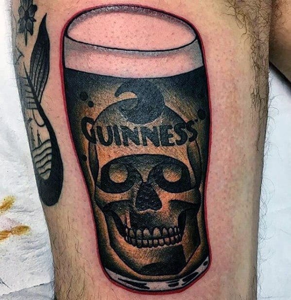 Bold tattoo of a Guinness pint glass with a skull subtly blended into the beer, combining brand tribute with dark imagery and a red outline for emphasis.
