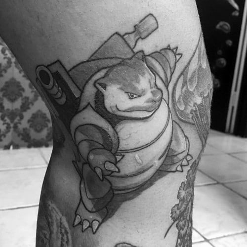 Black and grey Blastoise tattoo with sharp shading and strong lines, giving a bold and intense expression on the upper leg.