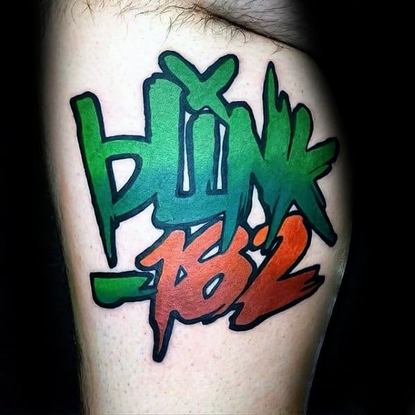 Tattoo featuring the word "BLINK" in vibrant green graffiti-style lettering, with "182" in bold red, creating a dynamic and energetic design on the upper arm.