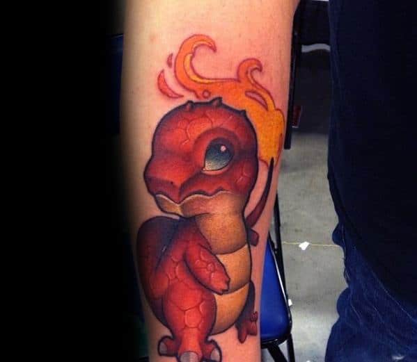 Realistic-style Charmander tattoo with textured reptilian skin, deep shading, and a glowing flame tail, placed on the forearm.